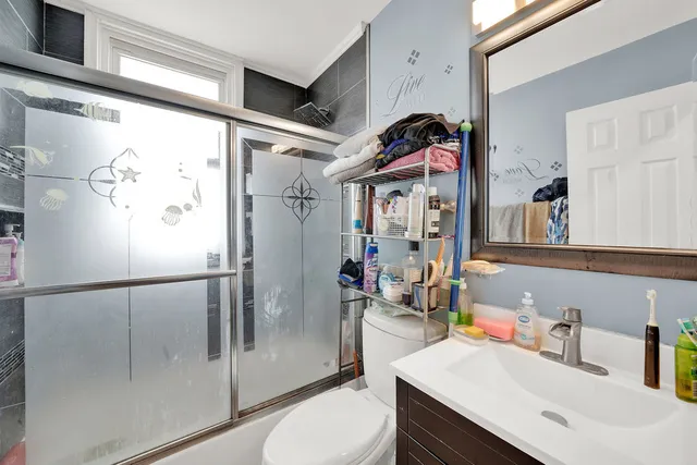 a bathroom with a sink toilet and shower