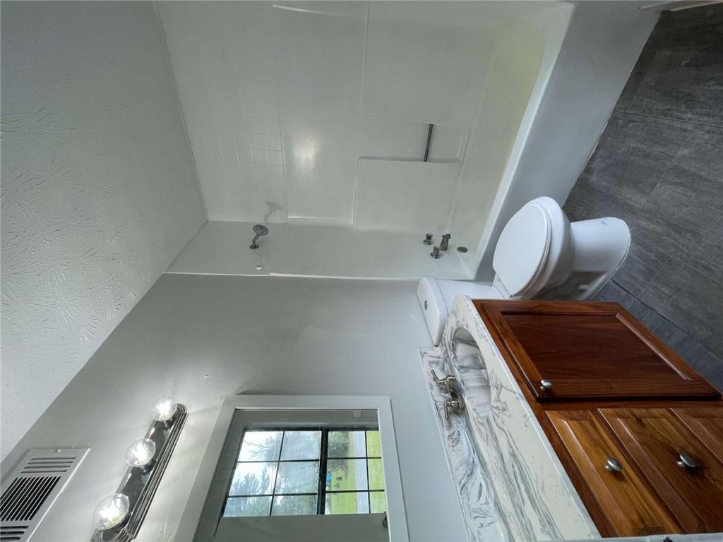 1088 Riva Ridge Drive Northwest Norcross, GA 30093 - Photo 18 of 43 a bathroom with a granite countertop sink toilet and shower