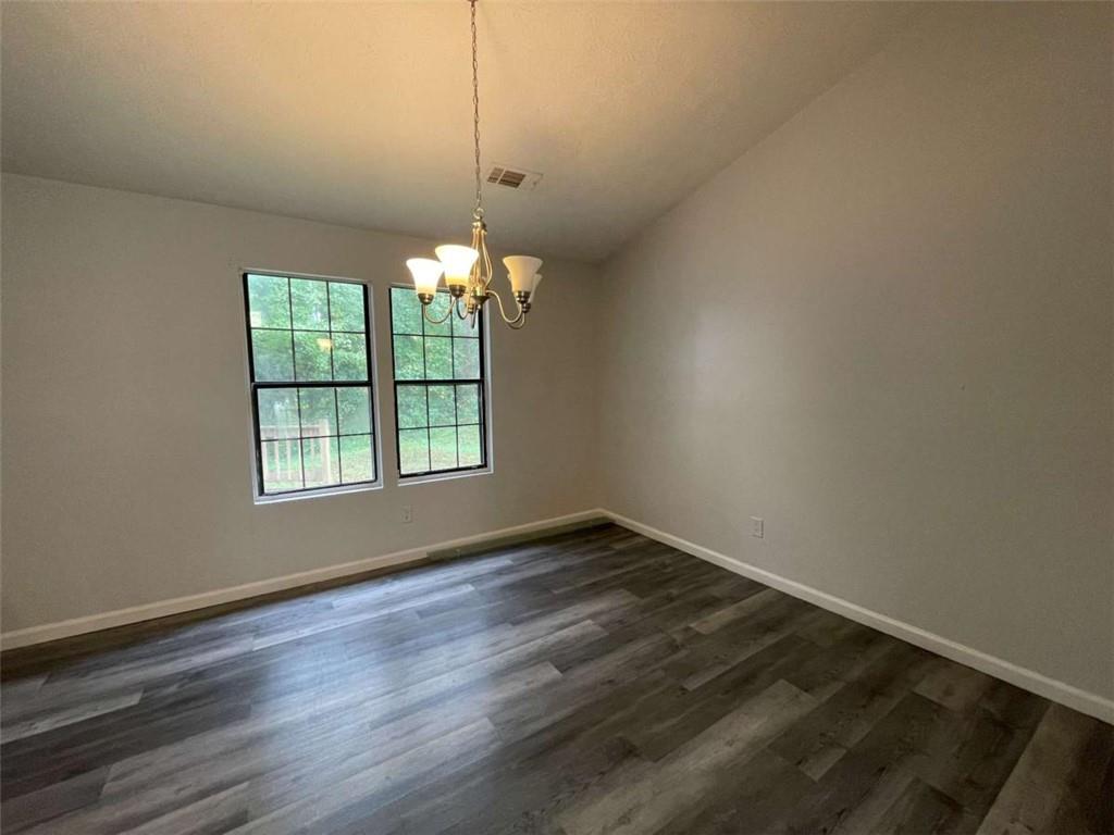 1088 Riva Ridge Drive Northwest Norcross, GA 30093 - Photo 6 of 43 an empty room with wooden floor and windows