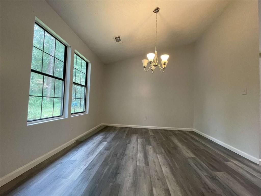 1088 Riva Ridge Drive Northwest Norcross, GA 30093 - Photo 8 of 43 a view of a room with wooden floor and a window