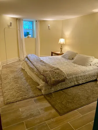 a bedroom with a bed and a mirror