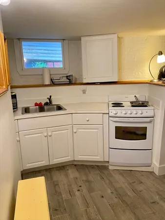 a kitchen with white cabinets and white appliances