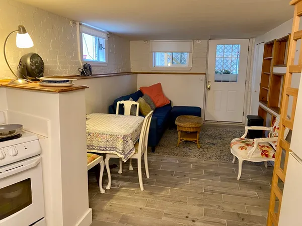 a dining room with furniture and wooden floor