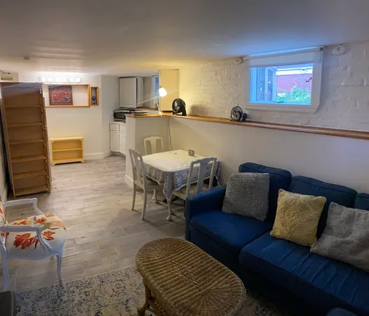 a living room with furniture and kitchen view