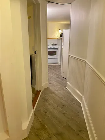 a view of a hallway with wooden floor