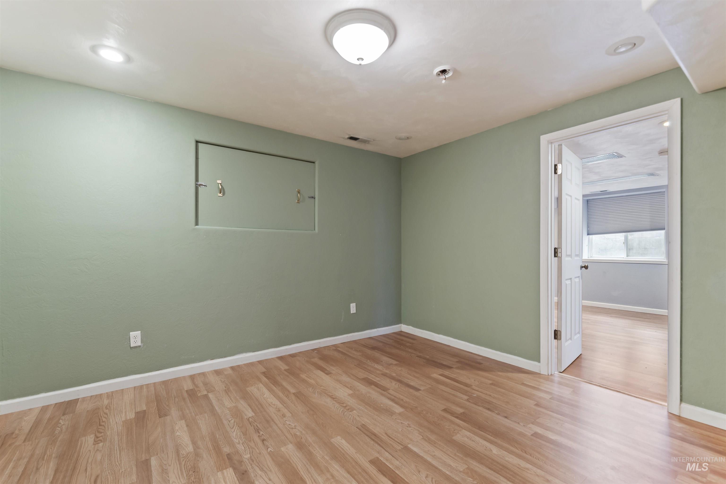 3160 East Springwood Drive Meridian, ID 83642 - Photo 18 of 41 Unfurnished room with light wood-style flooring and recessed lighting