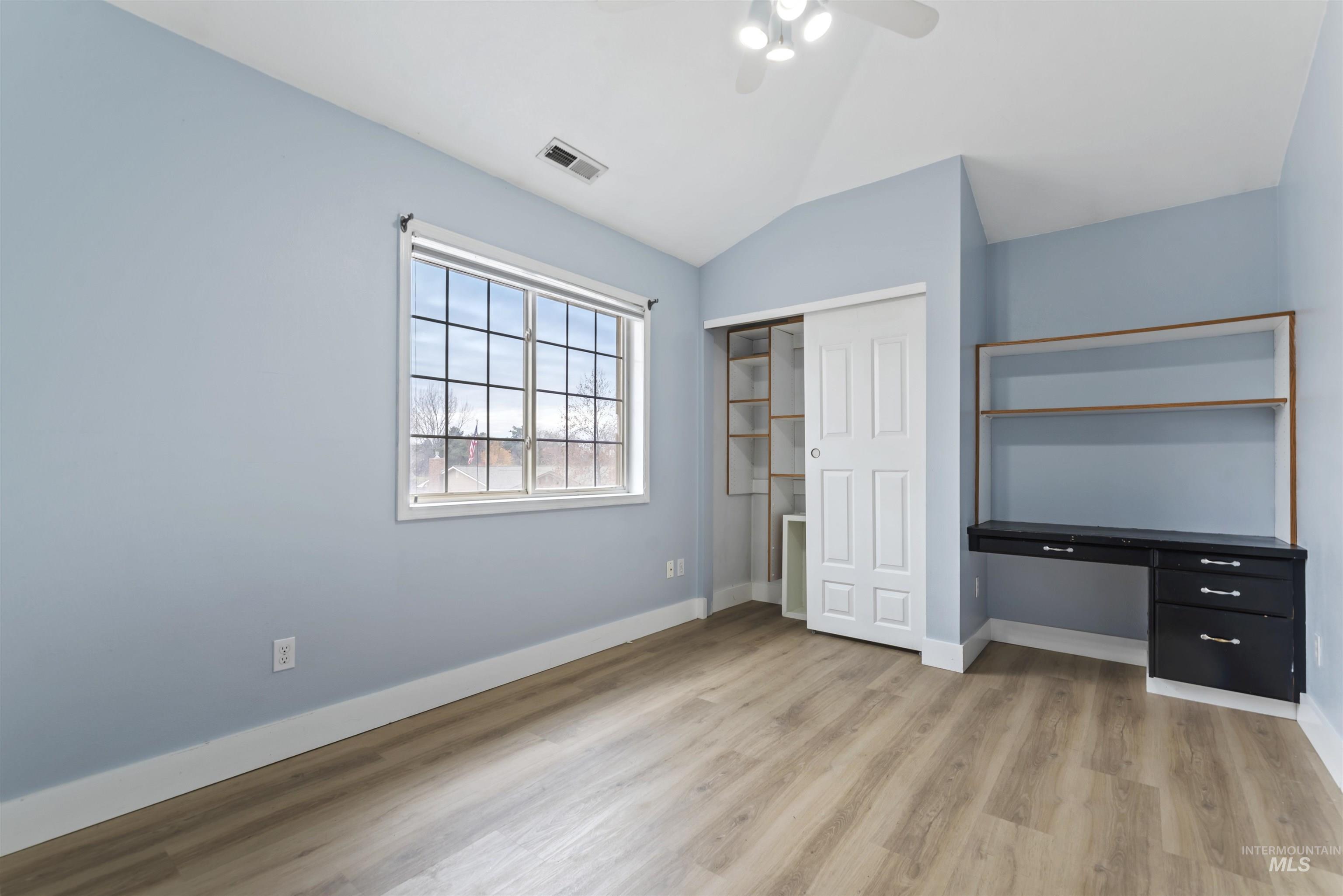 3160 East Springwood Drive Meridian, ID 83642 - Photo 20 of 41 Unfurnished bedroom featuring lofted ceiling, a closet, light wood-type flooring, and ceiling fan