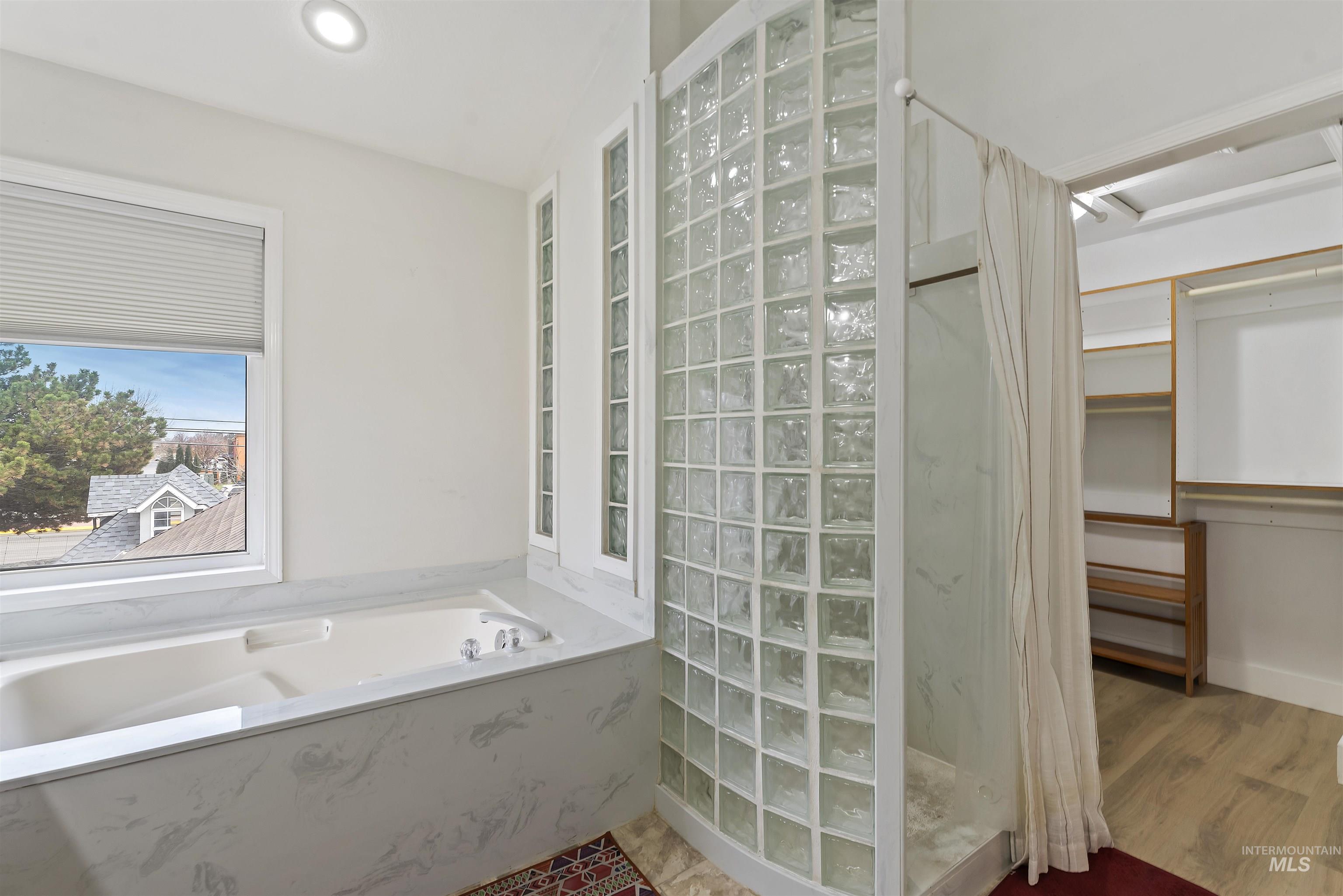 3160 East Springwood Drive Meridian, ID 83642 - Photo 24 of 41 Bathroom with a marble finish shower, a garden tub, a spacious closet, and recessed lighting