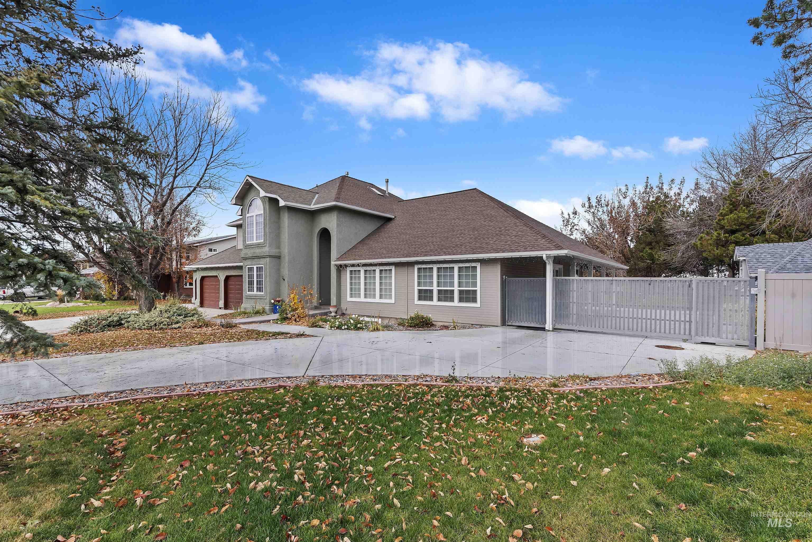 3160 East Springwood Drive Meridian, ID 83642 - Photo 3 of 41 View of front of home featuring concrete driveway, a shingled roof, and a gate