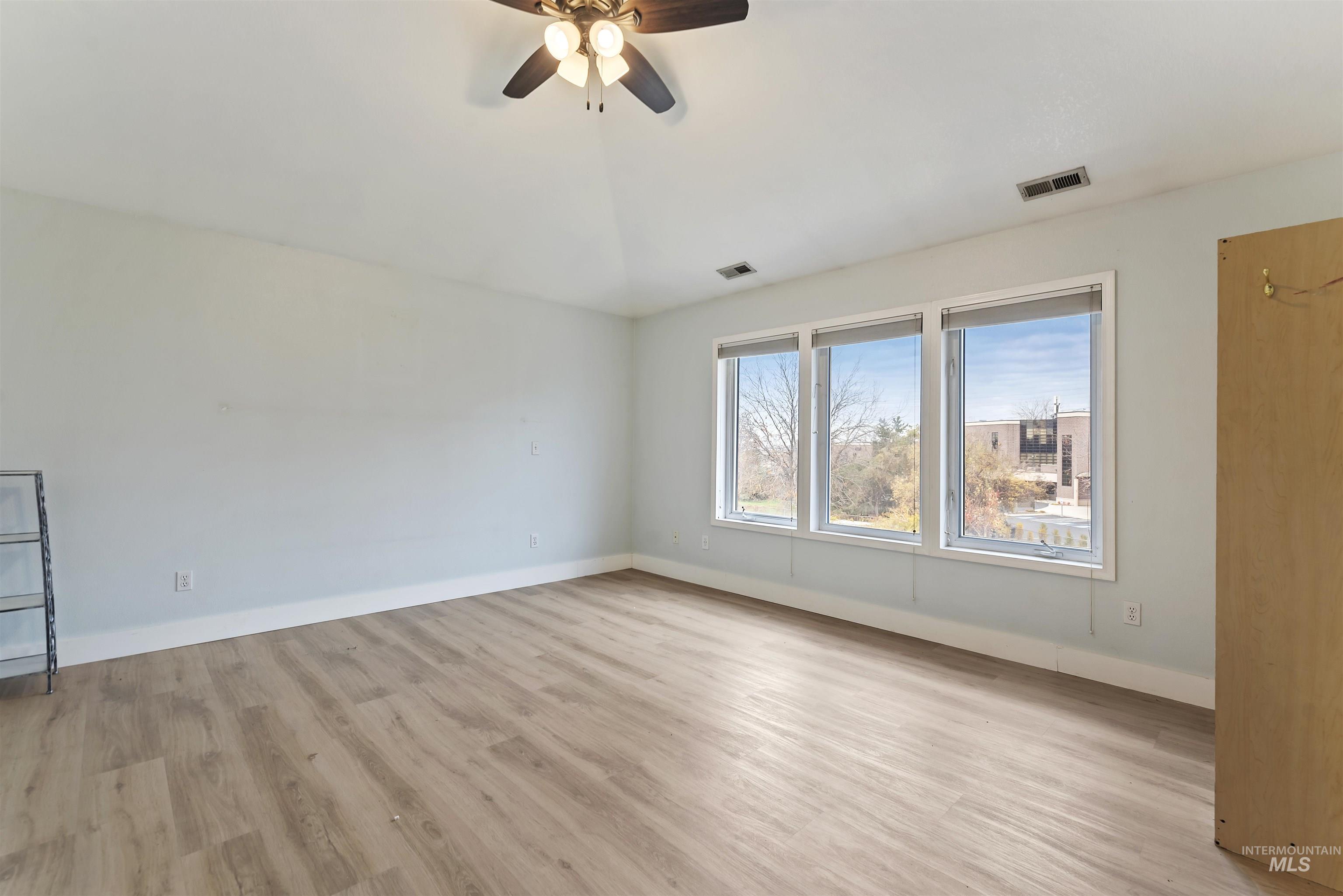 3160 East Springwood Drive Meridian, ID 83642 - Photo 33 of 41 Empty room featuring light wood finished floors and a ceiling fan