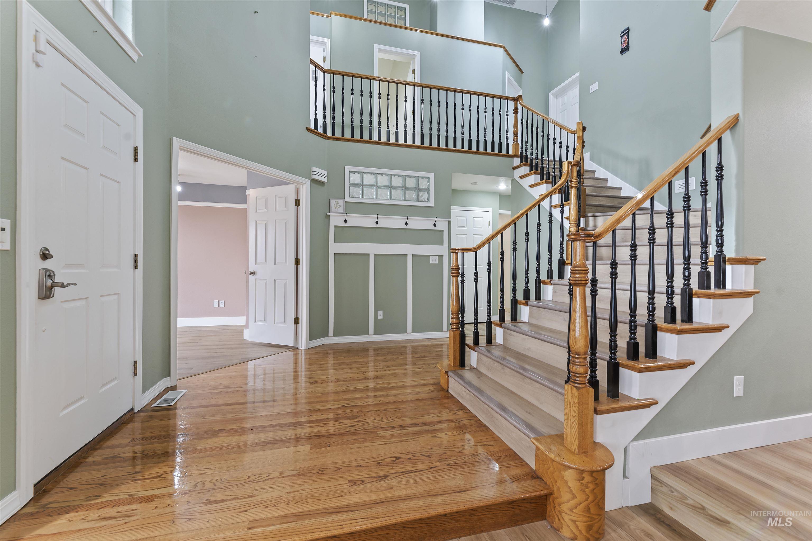 3160 East Springwood Drive Meridian, ID 83642 - Photo 5 of 41 Foyer entrance with light wood-style flooring and a towering ceiling