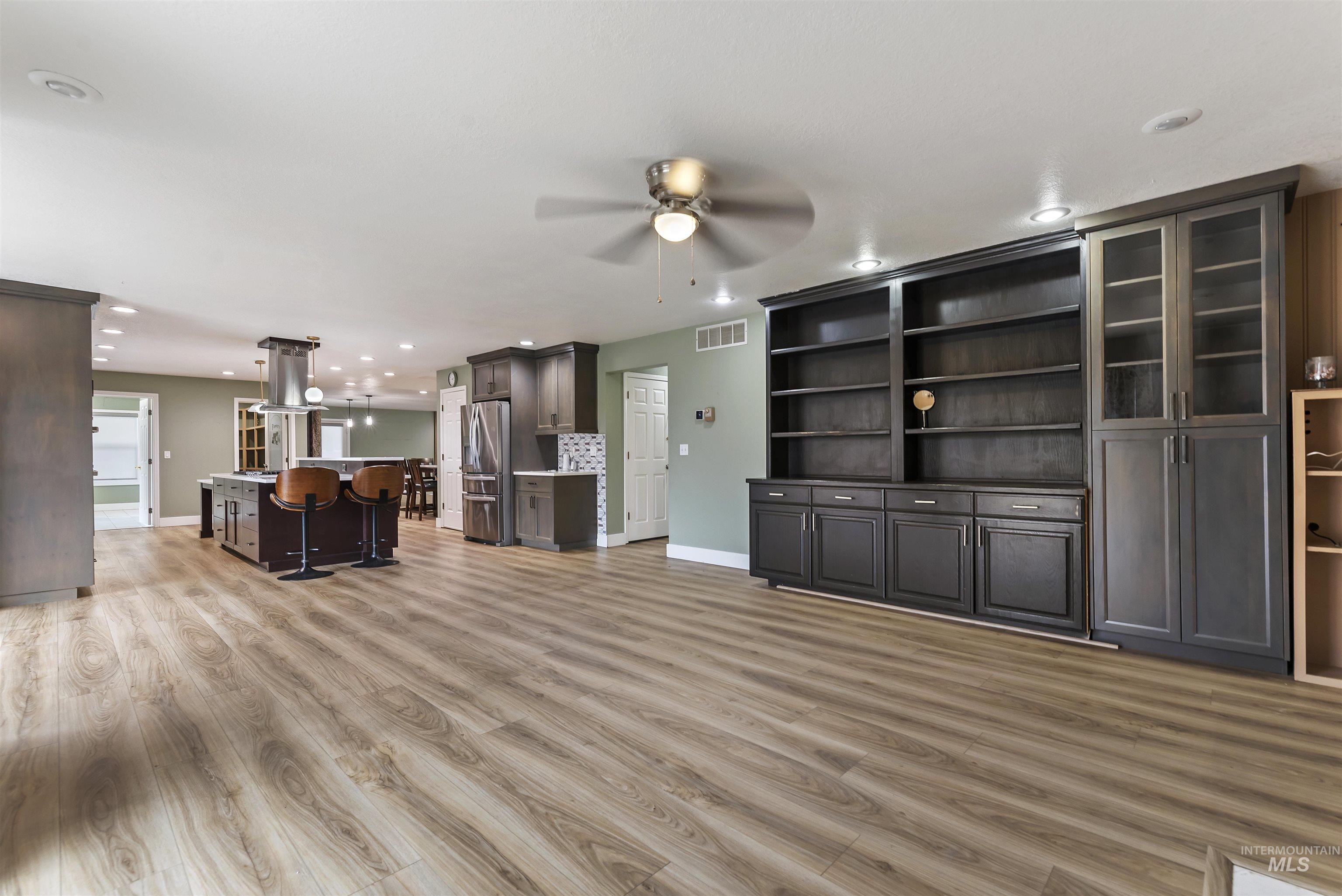 3160 East Springwood Drive Meridian, ID 83642 - Photo 7 of 41 Unfurnished living room featuring light wood finished floors, recessed lighting, and ceiling fan