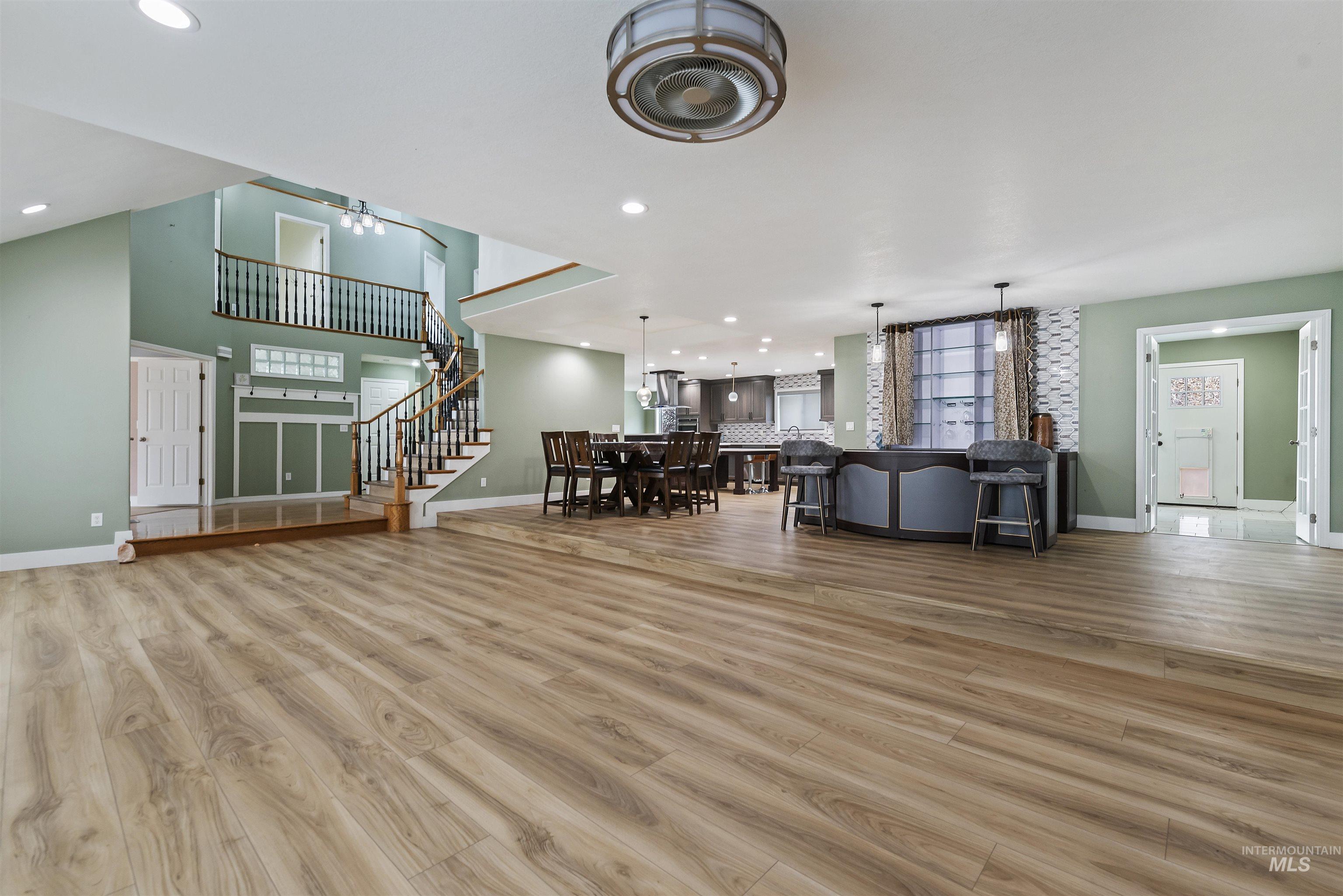3160 East Springwood Drive Meridian, ID 83642 - Photo 9 of 41 Living room featuring stairway, light wood finished floors, and recessed lighting
