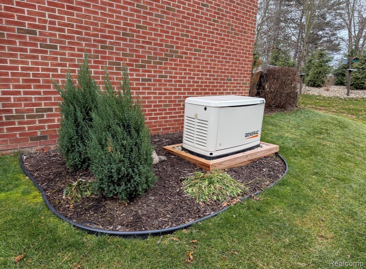 1876 Genoa Circle Howell, MI 48843 - Photo 4 of 36 Exterior view of brick siding and a power unit