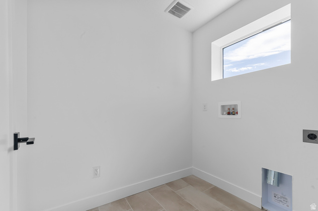 1341 West 2350 South, Unit 10 Perry, UT 84302 - Photo 17 of 18 Utility room featuring a rectangular window, tile flooring, and integrated dryer hookups