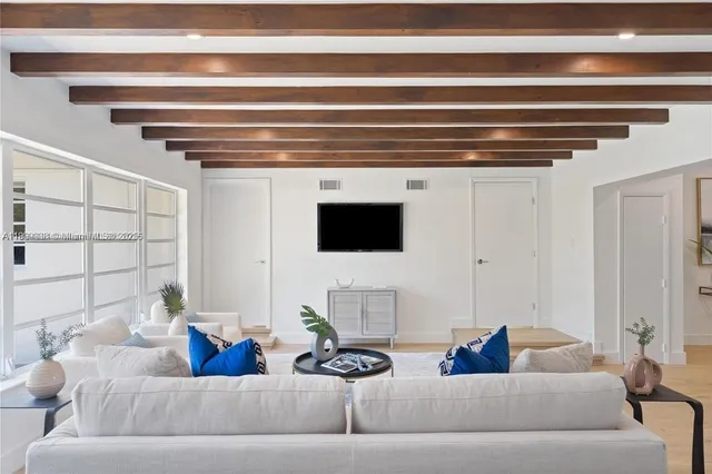 a living room with furniture and a potted plant