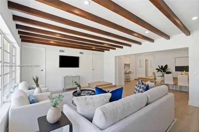 a living room with furniture and a floor to ceiling window
