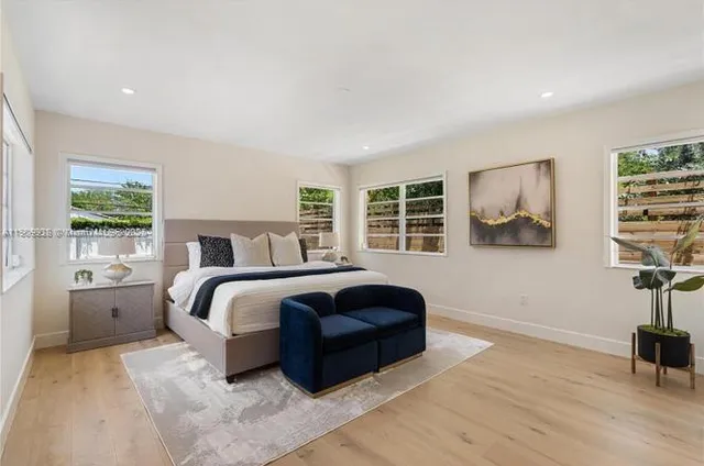 a bedroom with a large bed and a window