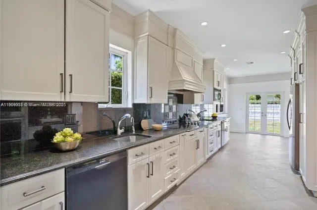 a kitchen with sink and cabinets