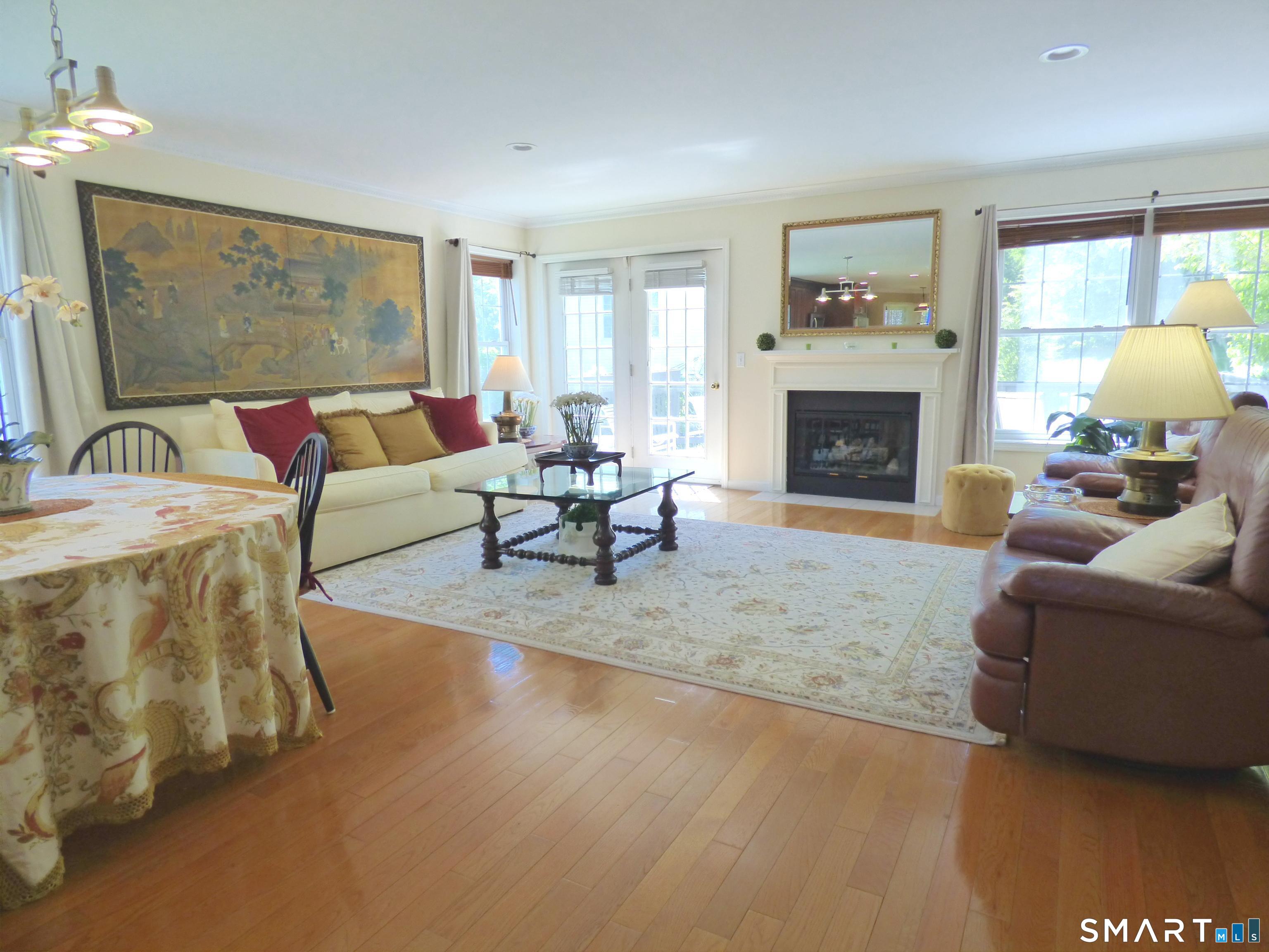 111 Logging Trail Road, Unit 111 Danbury, CT 06811 - Photo 6 of 34 Open Living/Dining Room with Gas FP and French Doors to Deck
