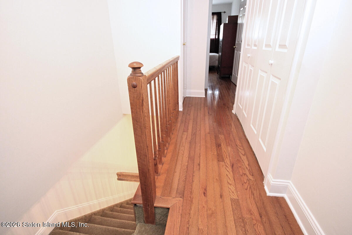 951 West Fingerboard Road Staten Island, NY 10304 - Photo 20 of 29 a view of a hallway with wooden floor and staircase
