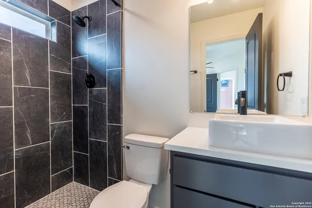 a bathroom with a sink toilet and shower