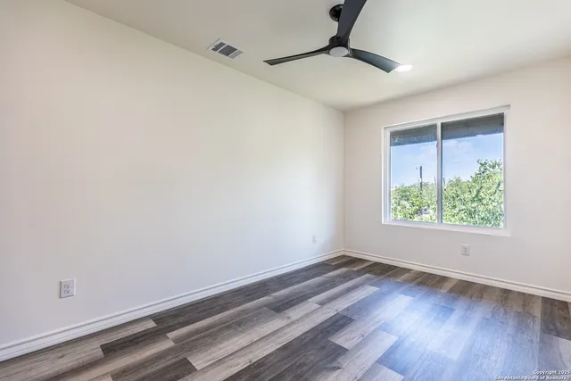 a room with a window and wooden floor