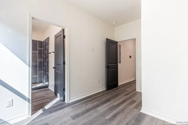 a view of hallway with wooden floor