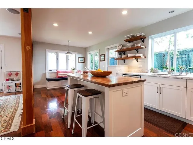a kitchen with a sink cabinets and a large window
