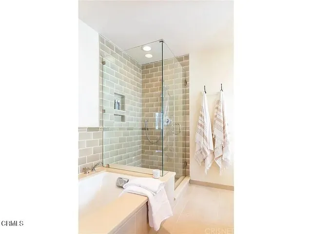 a bathroom with a bathtub and shower