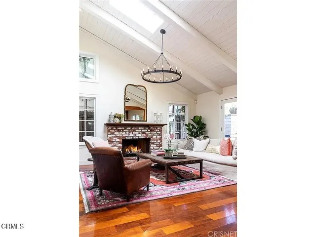 a living room with furniture a fireplace and a window