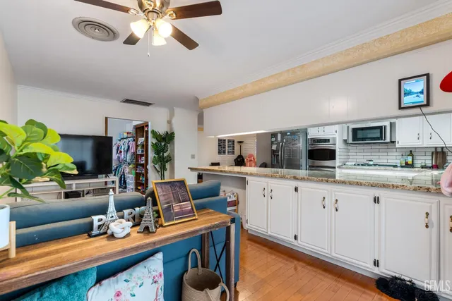 a kitchen with stainless steel appliances granite countertop a sink and cabinets