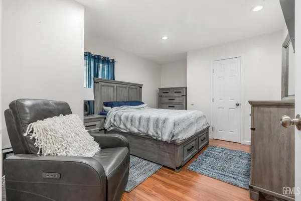 a bedroom with bed couch and window