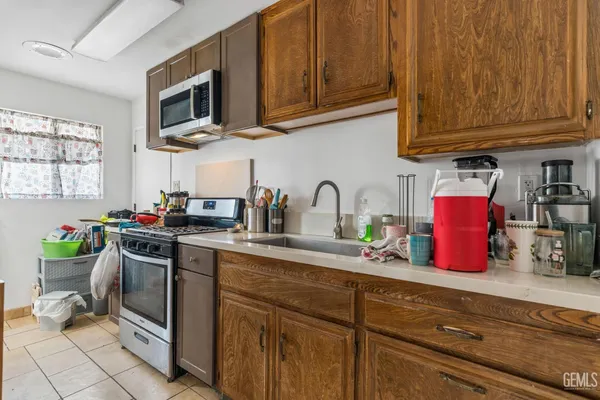 a kitchen with stainless steel appliances granite countertop a sink dishwasher stove and cabinets