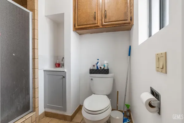 a white toilet sitting next to a bathroom sink