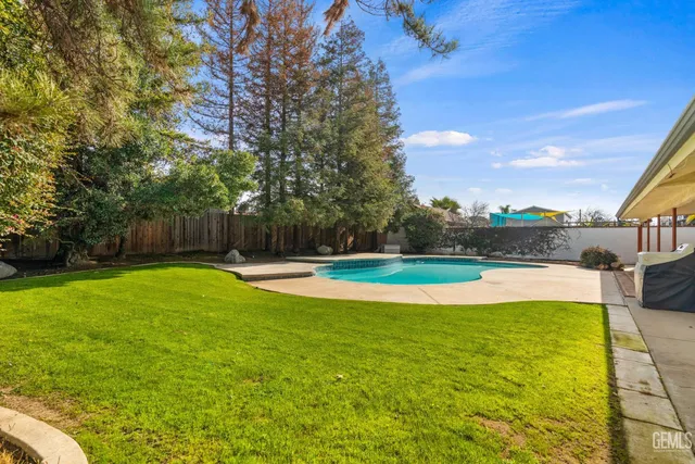 a view of a swimming pool with a yard