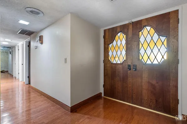 a view of an entryway with wooden floor