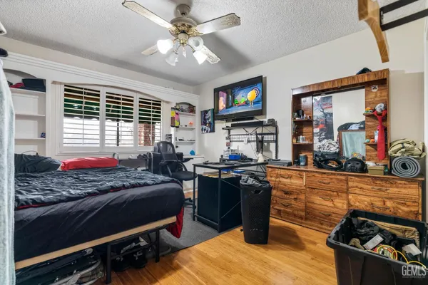 a bed room with a bed and a television