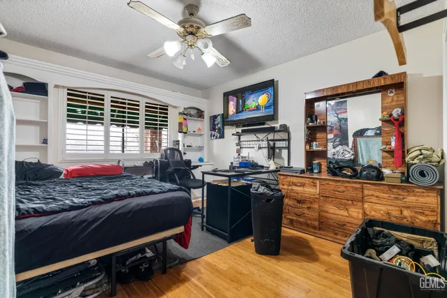 a bed room with a bed and a television