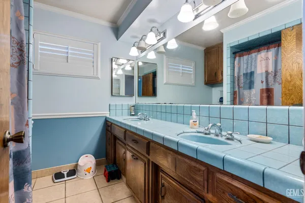 a bathroom with a double vanity sink and a mirror