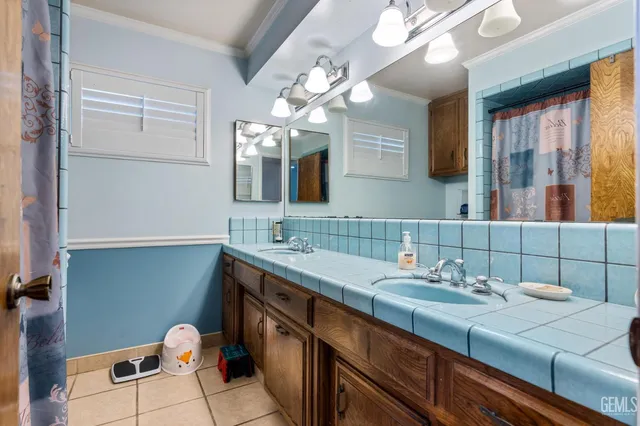 a bathroom with a double vanity sink and a mirror