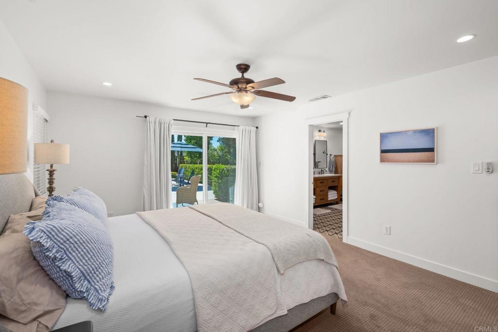 1848 Tavern Road Alpine, CA 91901 - Photo 28 of 45 a bedroom with a large bed and a chandelier