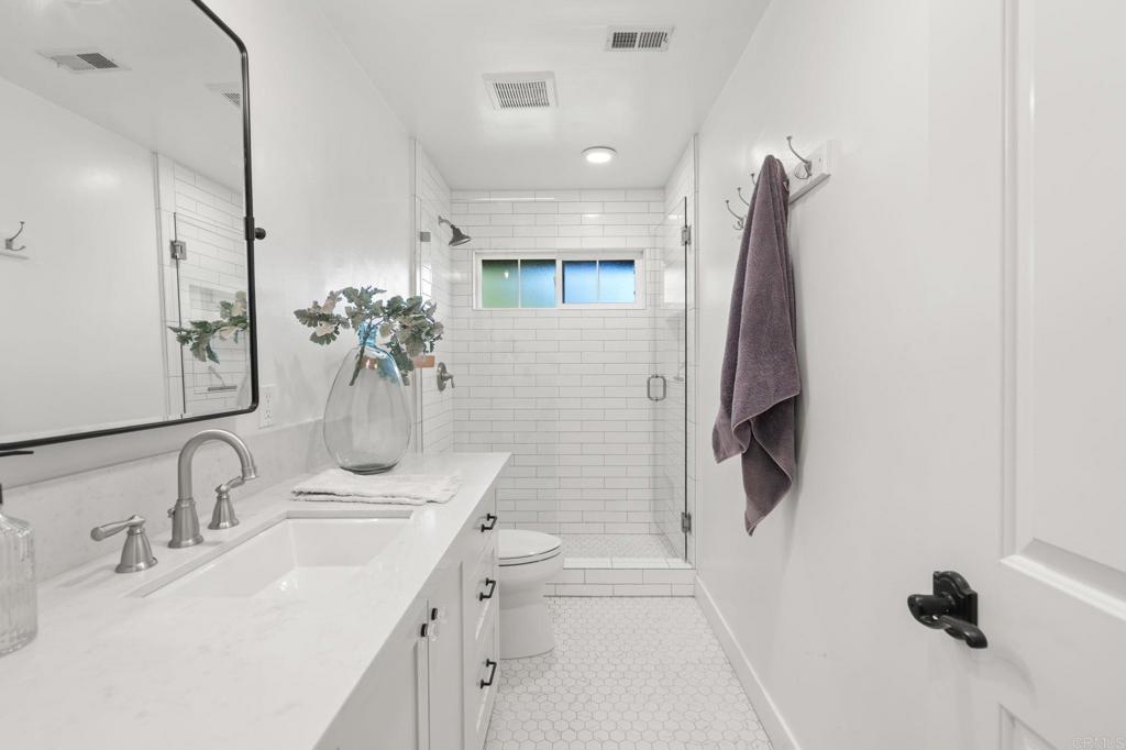 1848 Tavern Road Alpine, CA 91901 - Photo 34 of 45 a bathroom with a double vanity sink a mirror and shower