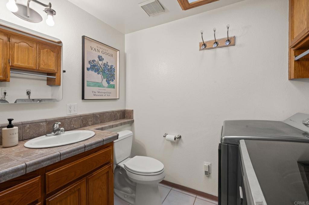 1848 Tavern Road Alpine, CA 91901 - Photo 39 of 45 a bathroom with a granite countertop sink toilet and mirror