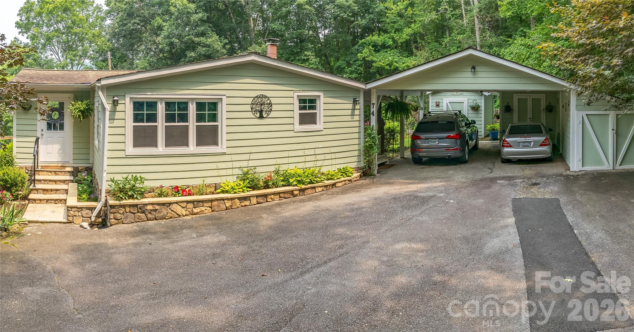 74 Huntley Road Fletcher, NC 28732 - Photo 41 of 45 a front view of a house with a yard and garage