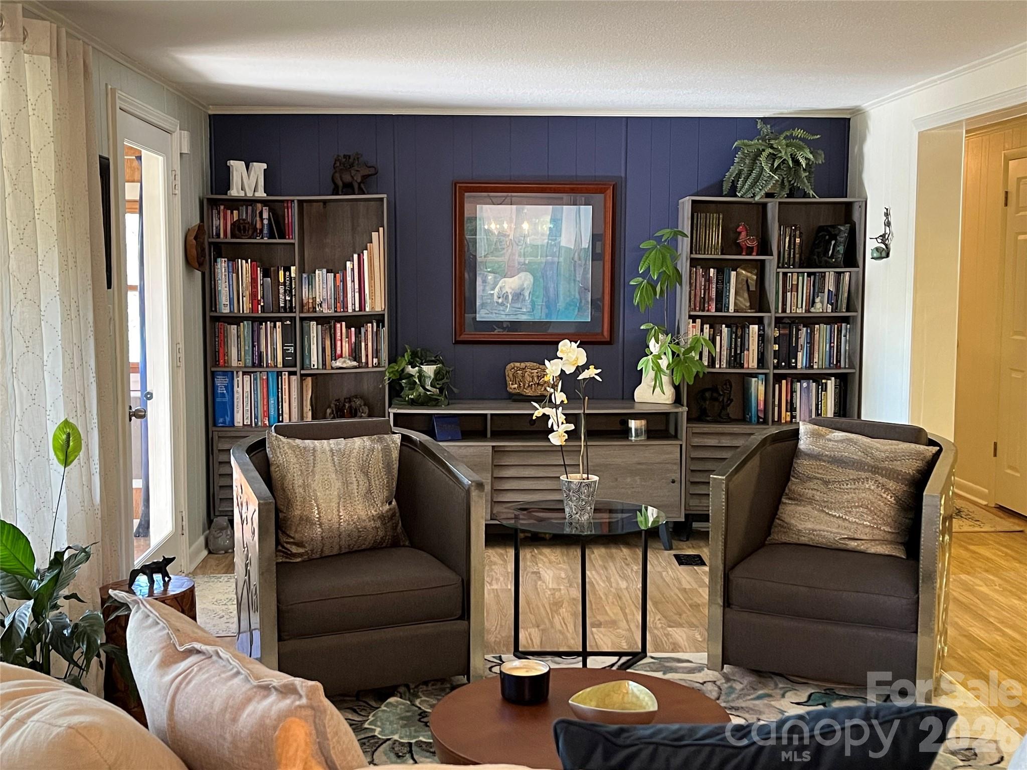 74 Huntley Road Fletcher, NC 28732 - Photo 6 of 45 a living room with furniture a bookshelf and a window