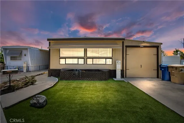a view of a house with a porch and a yard