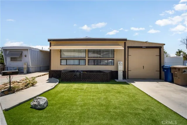 a view of a backyard with a garden and garage