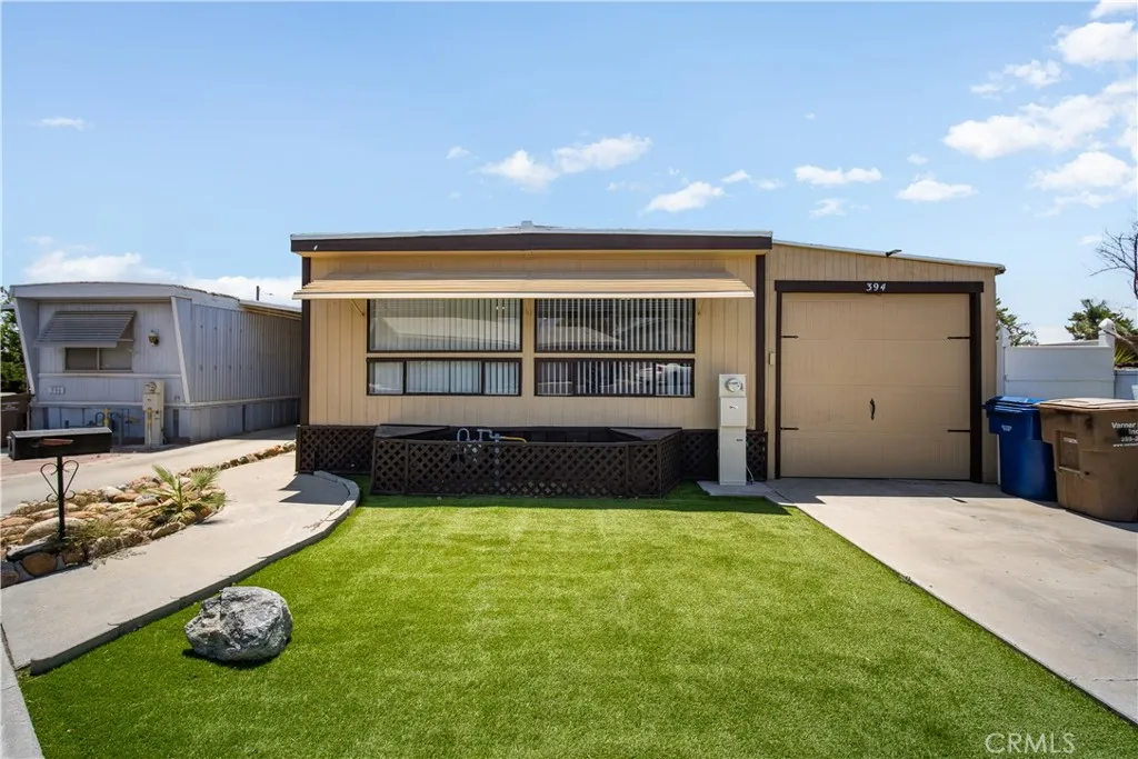 348 Petrol Road Bakersfield, CA 93308 - Photo 2 of 21 a view of a backyard with a garden and garage