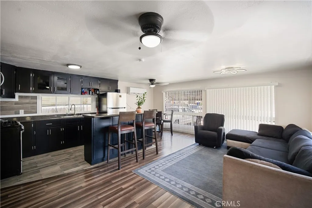348 Petrol Road Bakersfield, CA 93308 - Photo 8 of 21 a living room with furniture a dining table and kitchen view